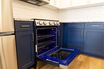 A blue oven with a glass door is in a kitchen.